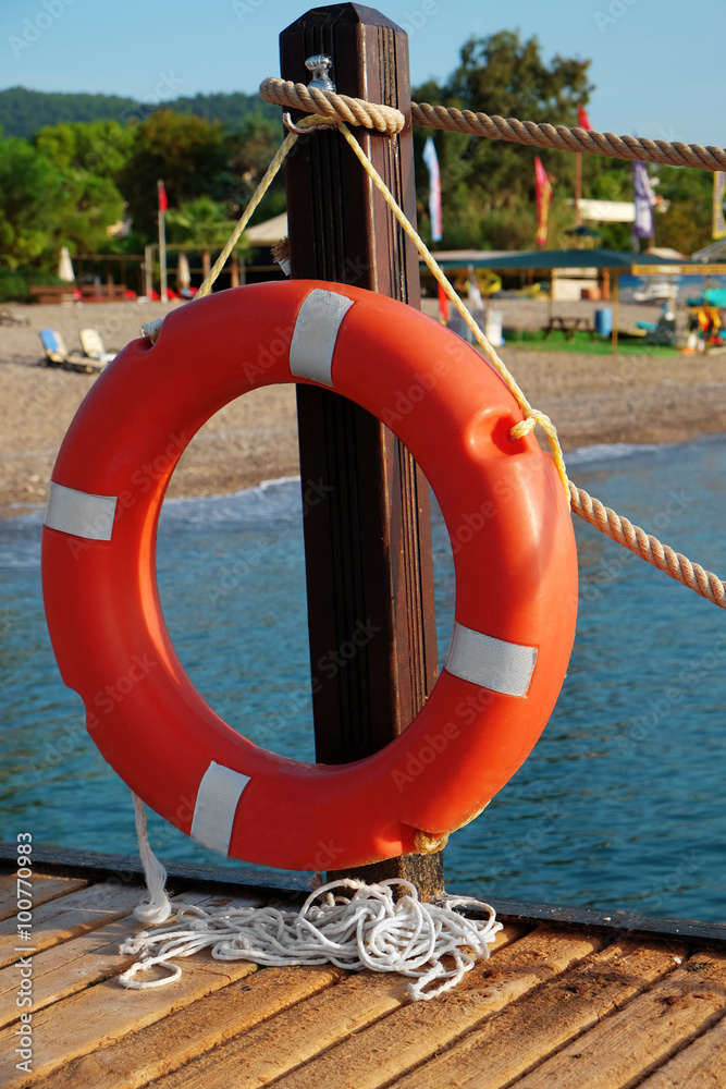 A life buoy hangs on the pier's handrail