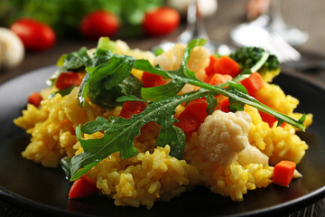 Sticker - Black plate with vegetable risotto on served wooden table