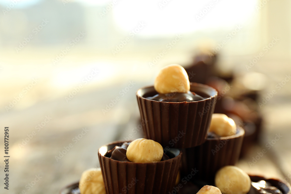 Composition of different chocolate candies on wooden background, close up