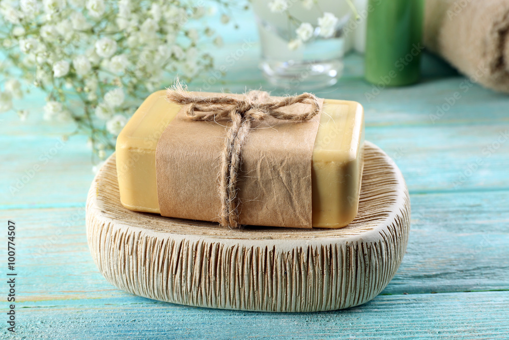 Soap on a dish over wooden background, close up