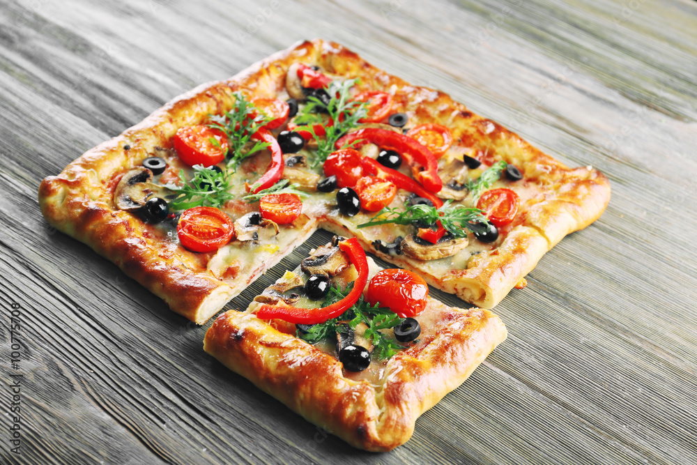 Freshly homemade pizza on wooden background