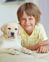 Wall Mural - Happy kid with a dog at home 