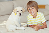 Fototapeta Przestrzenne - Happy kid with a dog at home 