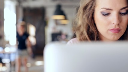 Wall Mural - young woman working on laptop at cafe