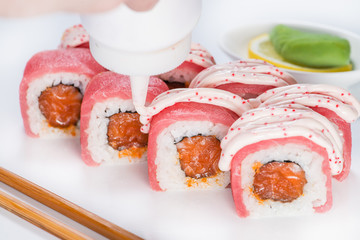 preparation of sushi, the process of pouring the sauce on the sa