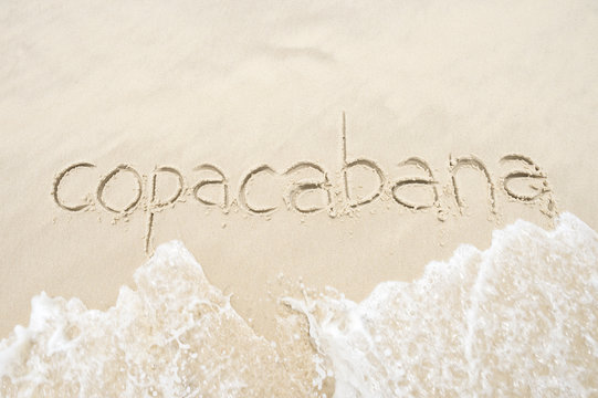 copacabana, the famous beach, message handwritten on smooth sand in rio de janeiro, brazil