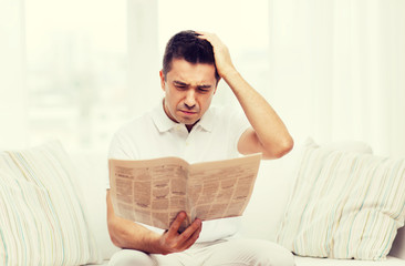 Poster - sad man reading newspaper at home