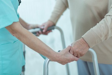 Canvas Print - Nurse helping disabled elderly lady