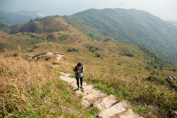 Canvas Print - Asian Woman hiking to the top of the mountain