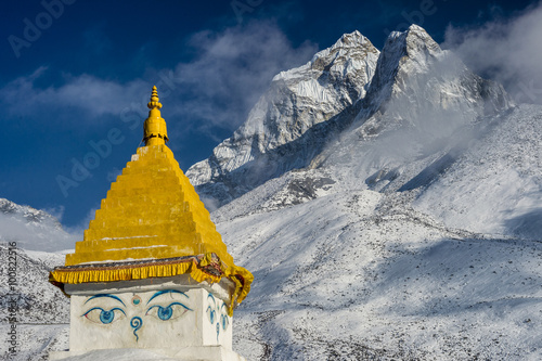 фотография Ama Dablam peak at sunset, with the top of a stupa in the foregr