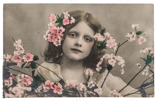 Naklejka ścienna Portrait of little girl with flowers. Vintage picture