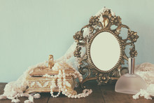 Antique Blank Victorian Style Frame, Perfume Bottle And White Pearls On Wooden Table. Retro Filtered And Toned. Template, Ready To Put Photography
