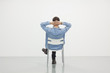 Man sitting on a chair in white room