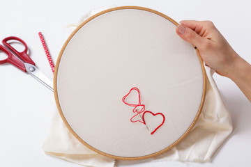 Woman sewing a Red Heart Shaped Decoration