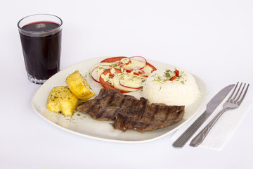 Grilled beef fillet assorted peruvian, rice, potatoes, tomatoes, chicha morada