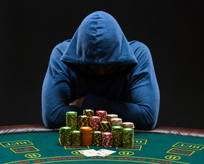 Portrait of a professional poker player sitting at pokers table