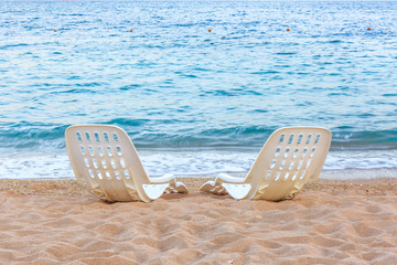 Landscape of Two Lonely beachchairs on the sand near sea