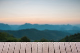 Fototapeta Na sufit - Wood table top on Majestic sunset in the mountains landscape