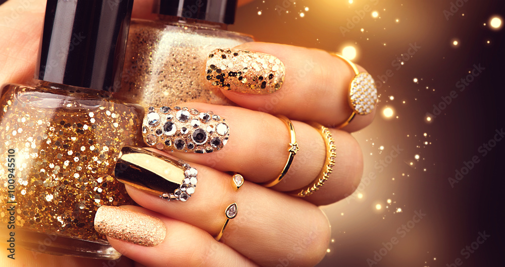 Golden manicure with gems and sparkles. Bottle of nailpolish, trendy accessories - obrazy, fototapety, plakaty 
