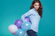© ZoomTeam - Young pretty woman with colored balloons