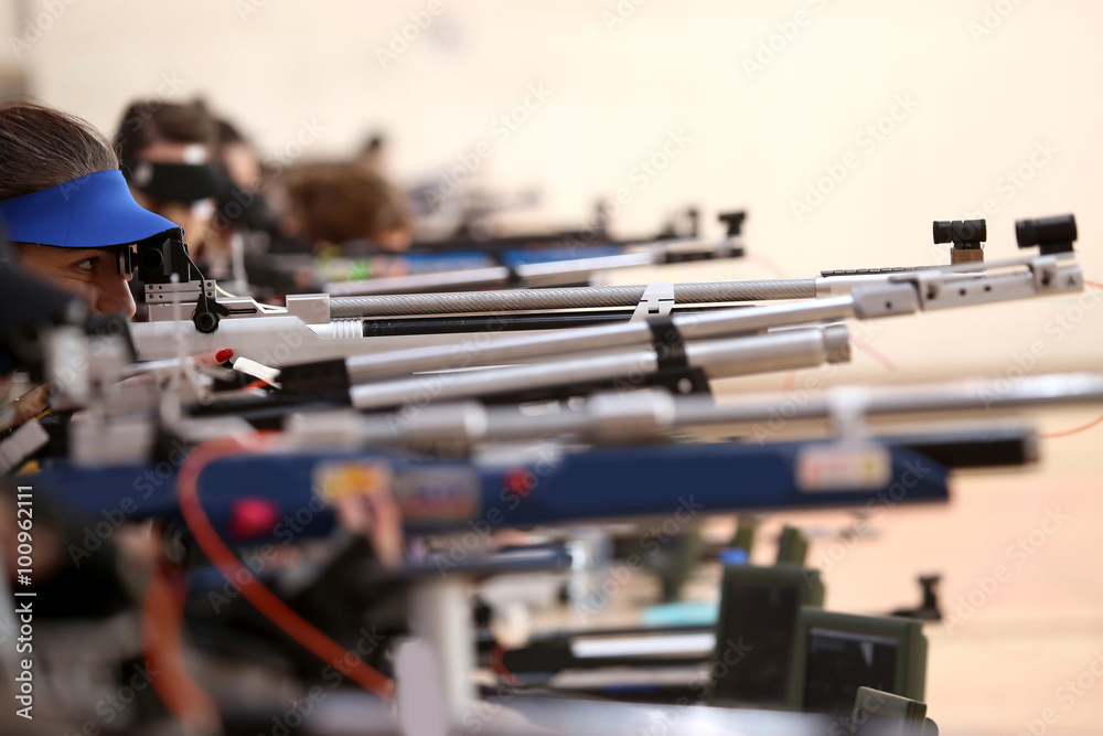 young woman aiming a pneumatic air rifle on sports competition Stock ...