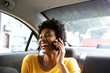 © mimagephotos - Laughing young woman in a car talking on mobile phone