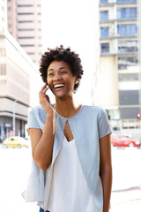 Wall Mural - Urban woman walking and talking on mobile phone