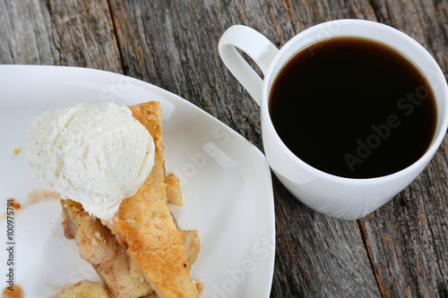 Fotografia, Obraz Slice of Apple Pie served on plate with vanilla ice cream, coffee and sunshine i