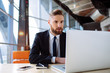 © baranq - Focused businessman working on laptop in the office