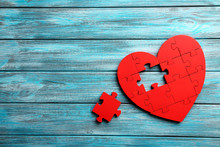 Red Puzzle Heart On Blue Wooden Background