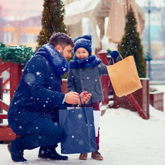 happy family on shopping in winter city