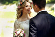Emotional happy beautiful blonde bride looking at handsome groom