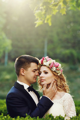 Wall Mural - Sensual beautiful young blonde bride and handsome groom at sunse