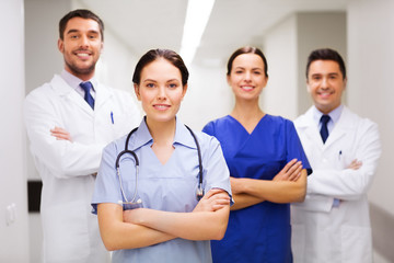 Poster - happy group of medics or doctors at hospital