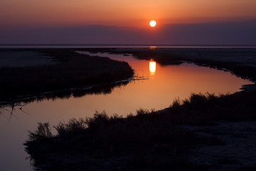 Wall Mural - beautiful nature landscape, sun reflected on water at sunset