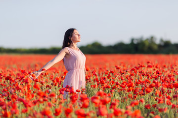 Wall Mural - Girl at blooming poppy field