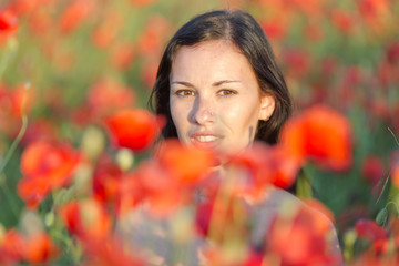 Wall Mural - Young woman in poppy field