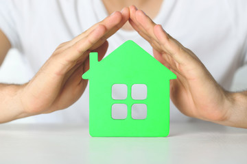 Sticker - Male hands and house, closeup