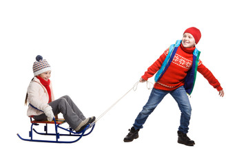 Two happy kids in winter clothes on sled