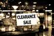A Clearance sale sign hanging in a shop window