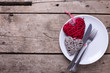Decorative red and grey hearts, knife and fork on white plate on