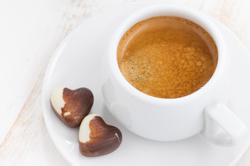 chocolate hearts and espresso on white wooden background