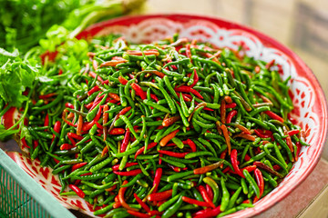 Wall Mural - Vegetables. Close Up Of Organic Spicy Hot Red And Green Chili Peppers In The Farmers Market In Thailand, Asia. Nutrition. Healthy Food Ingridient. Spices.