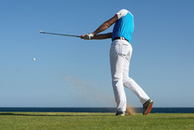 Golfer Hitting Ball With Force. The Grass Distribution The Blur Of Golf
