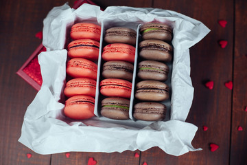 Assortment of pink and chocolate macaroon different lie in the c