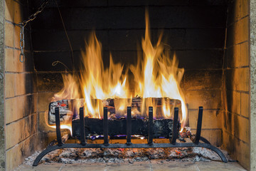 Fire in fireplace. Closeup of firewood burning in fire. Fireplace in the house. Firewood burns in a fireplace.