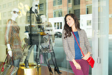 Mixed Race Woman Window Shopping In City