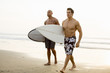 © Inti St Clair/Blend Images - Men carrying surfboards on beach