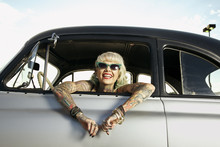 Woman With Tattoos Leaning Out Window Of 1951 Chevy