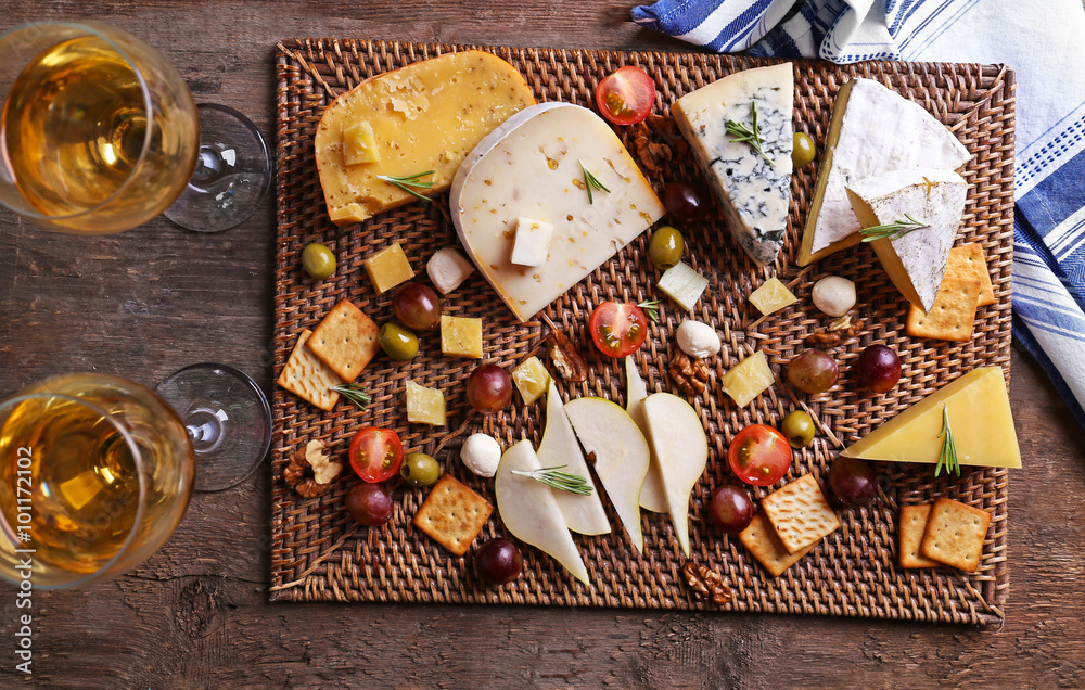 Different kinds of cheese on wooden background